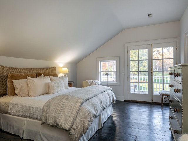 bedroom featuring vaulted ceiling, dark hardwood / wood-style floors, and access to outside