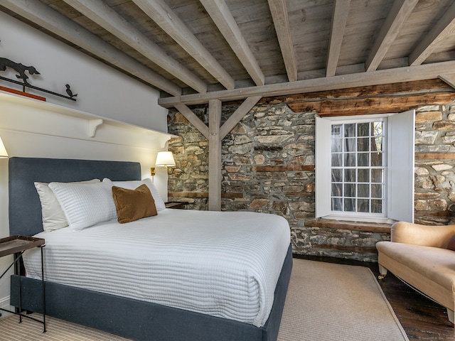 bedroom featuring hardwood / wood-style flooring, beamed ceiling, and wooden ceiling