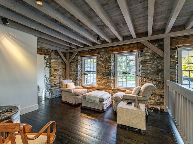 sitting room featuring beamed ceiling, dark hardwood / wood-style floors, and a healthy amount of sunlight