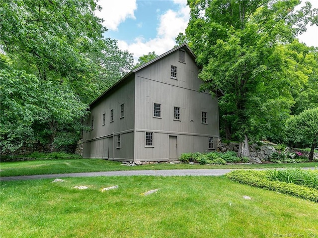 view of side of home with a lawn