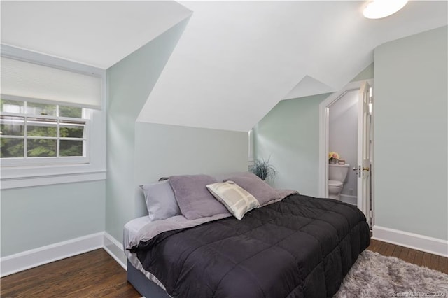 bedroom with lofted ceiling and dark wood-type flooring