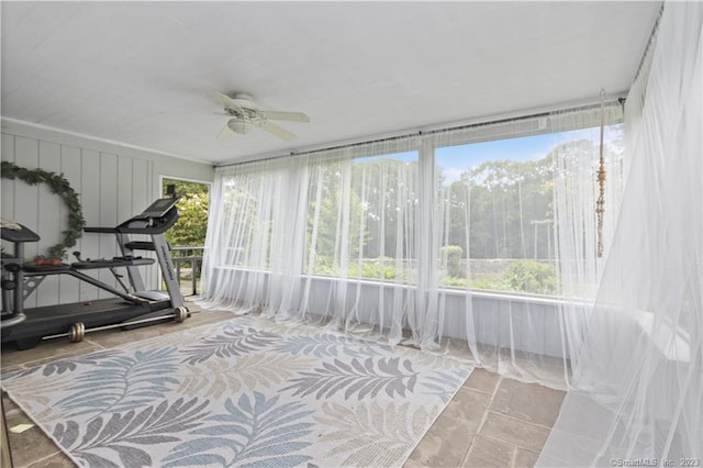 sunroom / solarium featuring ceiling fan