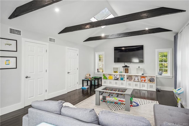 living room featuring lofted ceiling with skylight and dark hardwood / wood-style floors