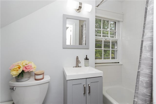 full bathroom with vanity, shower / bath combo, and toilet