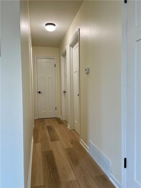 hall with light hardwood / wood-style flooring