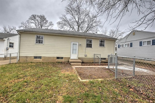 rear view of property with a yard