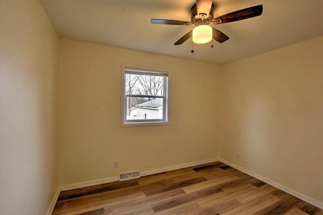 unfurnished room with ceiling fan and light wood-type flooring