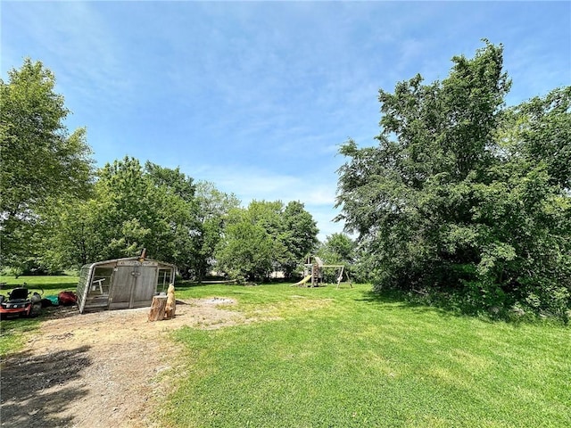 2281 US Rte 40, Casey, IL 62420 - view of green lawn with a playground and view of wooded area