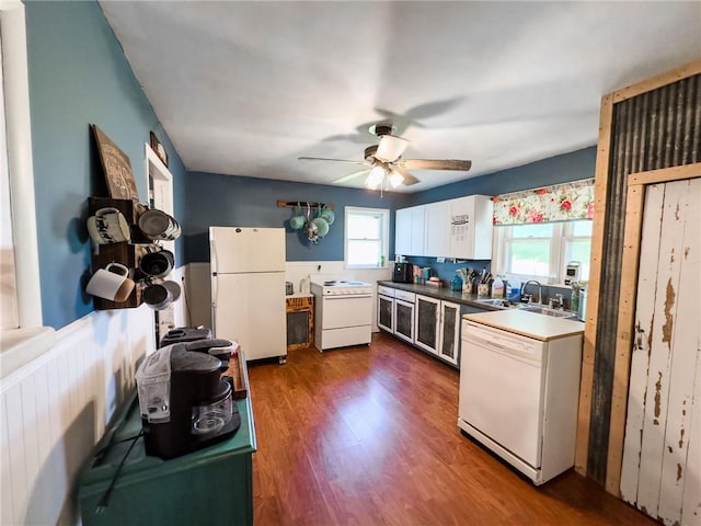 2281 US Rte 40, Casey, IL 62420 - kitchen with white appliances, a wainscoted wall, a ceiling fan, dark wood-type flooring, and a sink