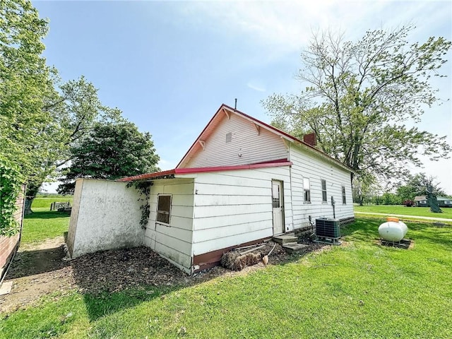 2281 US Rte 40, Casey, IL 62420 - view of home's exterior with a yard, central AC unit, and entry steps