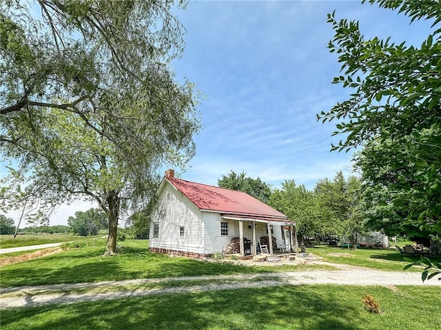 2281 US Rte 40, Casey, IL 62420 - view of front facade featuring a front yard, a chimney, metal roof, and covered porch