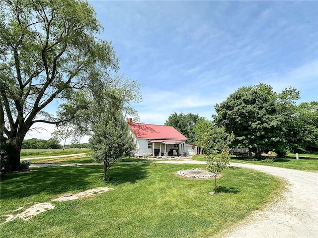 2281 US Rte 40, Casey, IL 62420 - obstructed view of property with a front yard, metal roof, curved driveway, and a chimney
