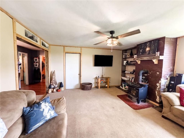 2281 US Rte 40, Casey, IL 62420 - living room featuring a wood stove, ceiling fan, and carpet