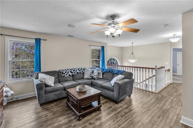 1435 Ashland Ave, Mt Zion, IL 62549 - living room featuring wood finished floors, a ceiling fan, a textured ceiling, and baseboards