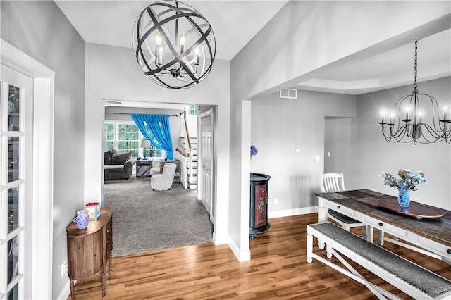 1435 Ashland Ave, Mt Zion, IL 62549 - dining room with a chandelier, wood finished floors, baseboards, and stairway