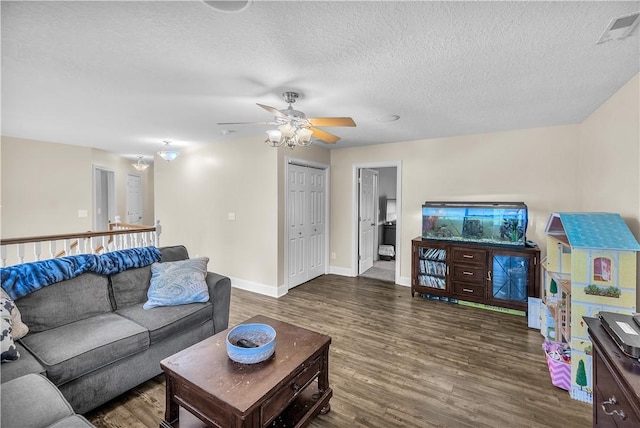 1435 Ashland Ave, Mt Zion, IL 62549 - living room featuring dark wood finished floors, a ceiling fan, baseboards, and a textured ceiling