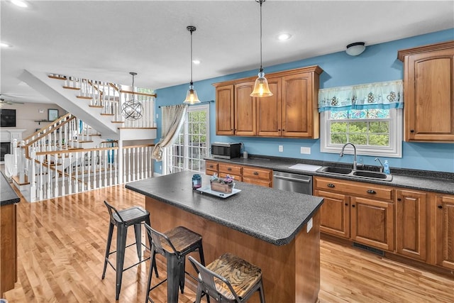 1435 Ashland Ave, Mt Zion, IL 62549 - kitchen with a sink, stainless steel appliances, dark countertops, brown cabinetry, and plenty of natural light