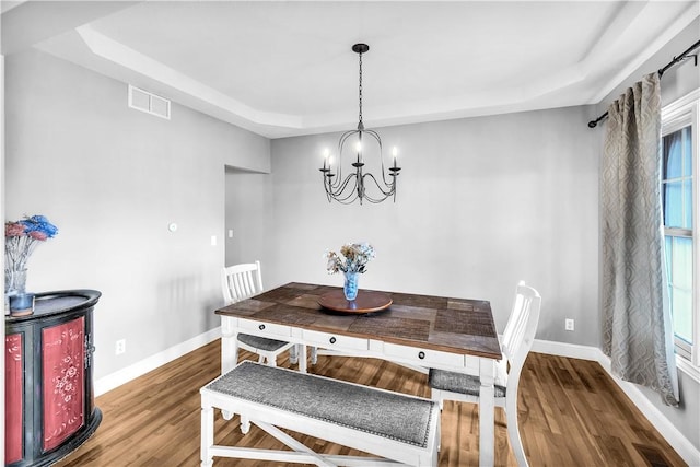 1435 Ashland Ave, Mt Zion, IL 62549 - dining room with a tray ceiling, baseboards, a chandelier, and wood finished floors