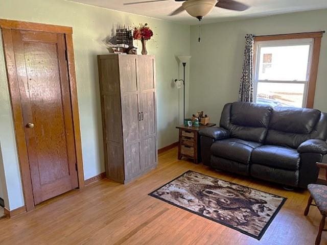 609 S 2nd St, Effingham, IL 62401 - living room featuring a ceiling fan, light wood-style floors, and baseboards