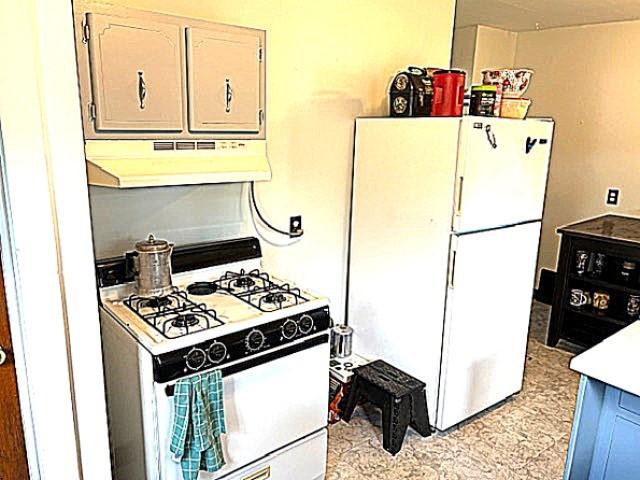 609 S 2nd St, Effingham, IL 62401 - kitchen with exhaust hood, white appliances, and light countertops