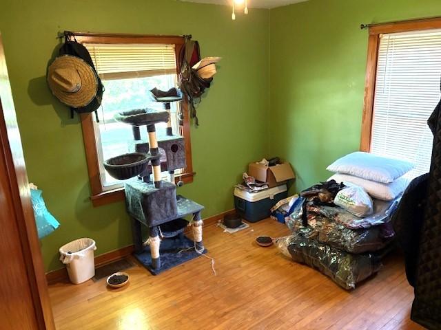 609 S 2nd St, Effingham, IL 62401 - bedroom with multiple windows, wood finished floors, and baseboards