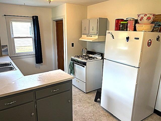 609 S 2nd St, Effingham, IL 62401 - kitchen featuring white appliances, under cabinet range hood, light countertops, and gray cabinets