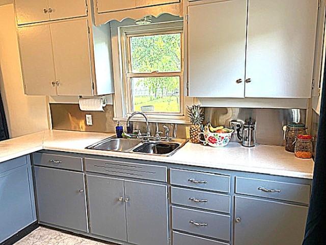 609 S 2nd St, Effingham, IL 62401 - kitchen featuring gray cabinets, a sink, and light countertops