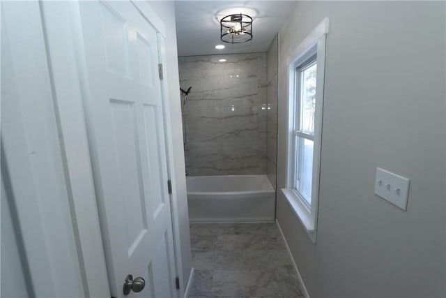 bathroom featuring tiled shower / bath