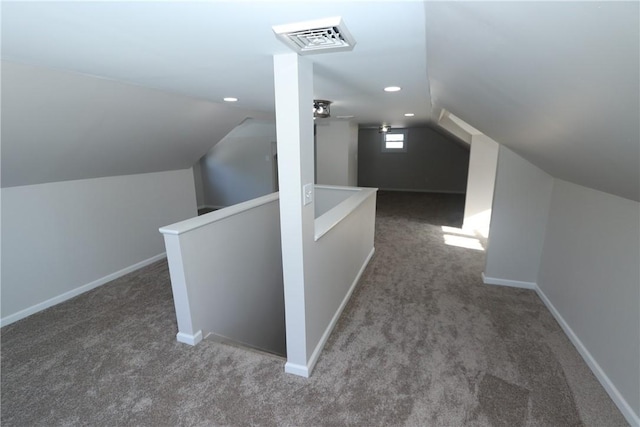 additional living space featuring lofted ceiling and carpet floors