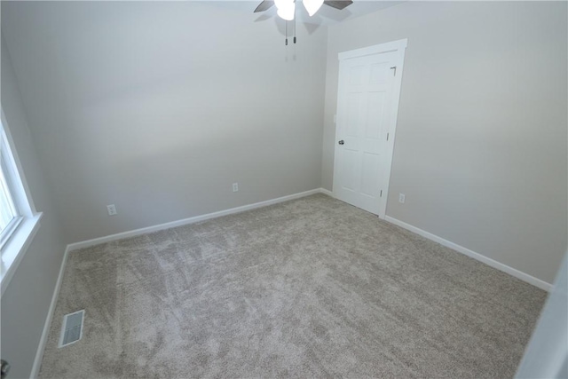 unfurnished room featuring ceiling fan and light colored carpet