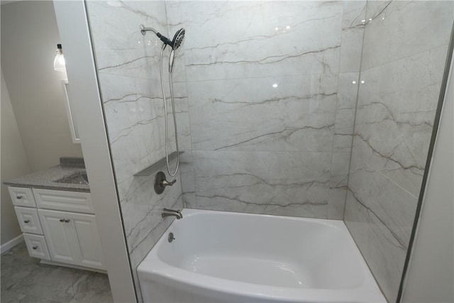 bathroom with tiled shower / bath and vanity