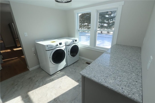 clothes washing area with separate washer and dryer