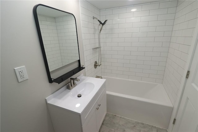 bathroom with vanity and tiled shower / bath