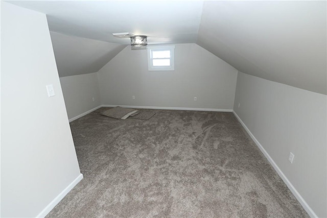 additional living space featuring lofted ceiling and carpet floors