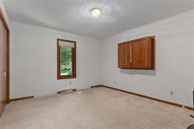 2104 Sycamore St, Effingham, IL 62401 - spare room with carpet and a textured ceiling