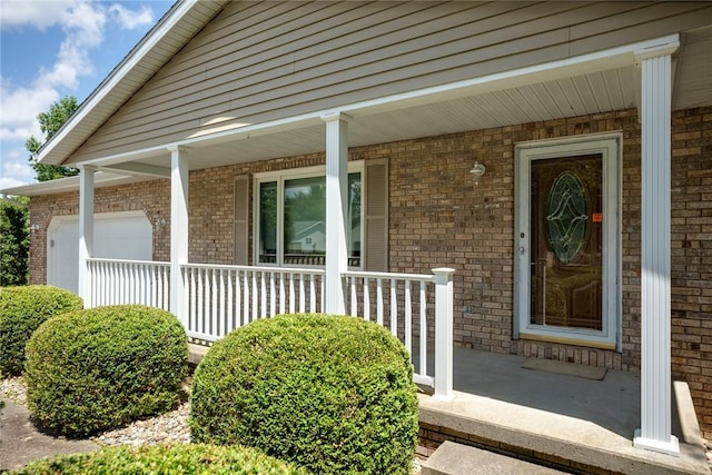 2104 Sycamore St, Effingham, IL 62401 - entrance to property with covered porch, an attached garage, and brick siding