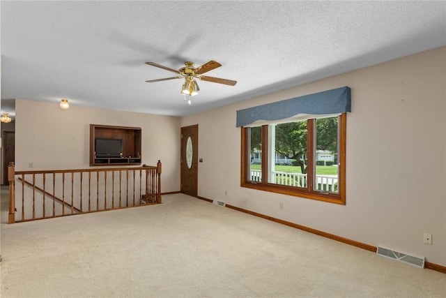 2104 Sycamore St, Effingham, IL 62401 - unfurnished living room featuring carpet flooring, a ceiling fan, and a textured ceiling