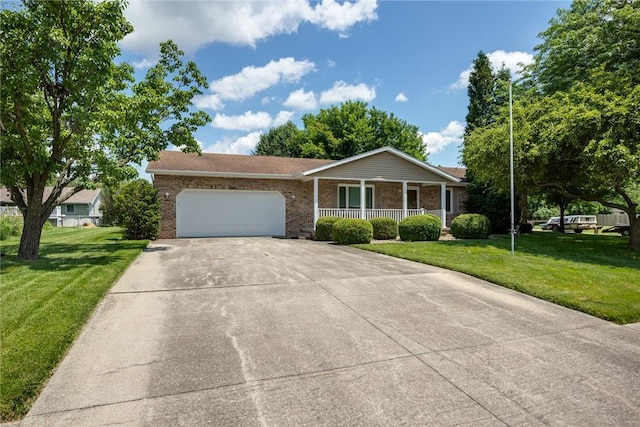 2104 Sycamore St, Effingham, IL 62401 - ranch-style house with a porch, brick siding, concrete driveway, an attached garage, and a front lawn