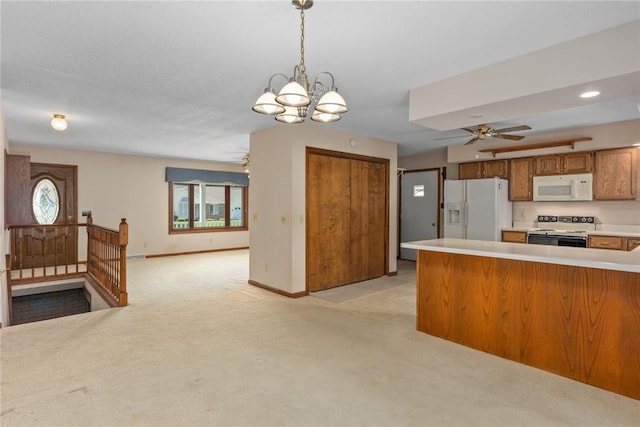 2104 Sycamore St, Effingham, IL 62401 - kitchen featuring white appliances, brown cabinets, light carpet, ceiling fan, and light countertops