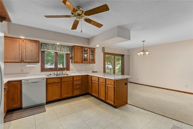 2104 Sycamore St, Effingham, IL 62401 - kitchen featuring dishwasher, a peninsula, brown cabinets, light carpet, and a textured ceiling
