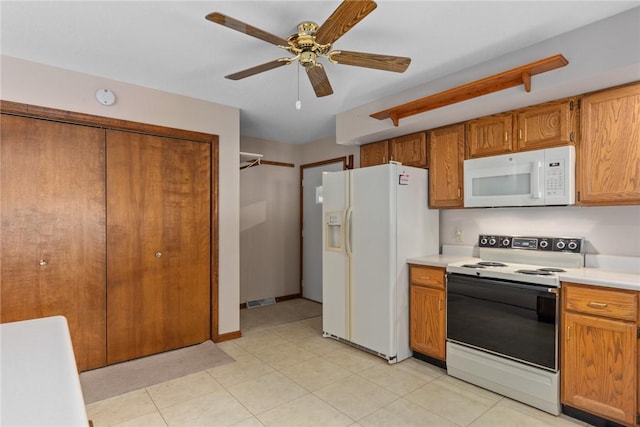 2104 Sycamore St, Effingham, IL 62401 - kitchen with white appliances, light countertops, brown cabinetry, and ceiling fan