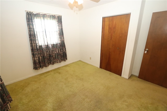 unfurnished bedroom featuring ceiling fan and light colored carpet