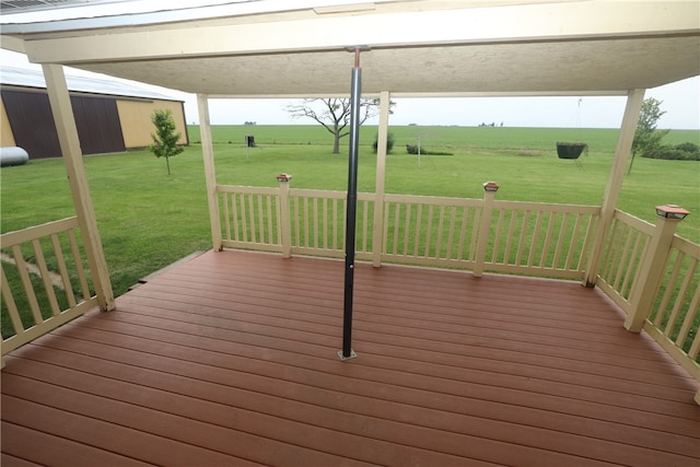 deck with a lawn and a rural view