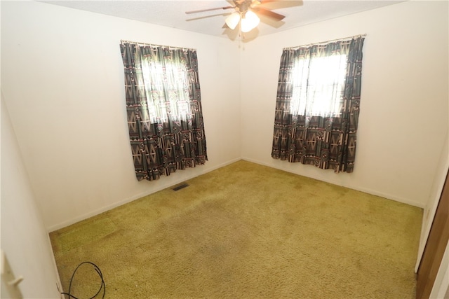 unfurnished room with carpet and ceiling fan