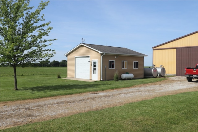 view of outdoor structure with a yard and a garage