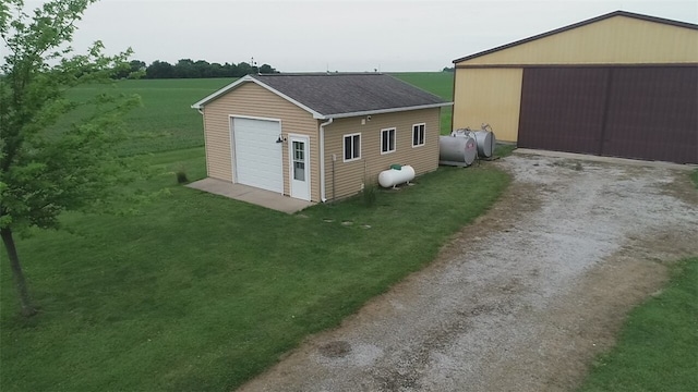 view of side of property featuring a yard and an outdoor structure