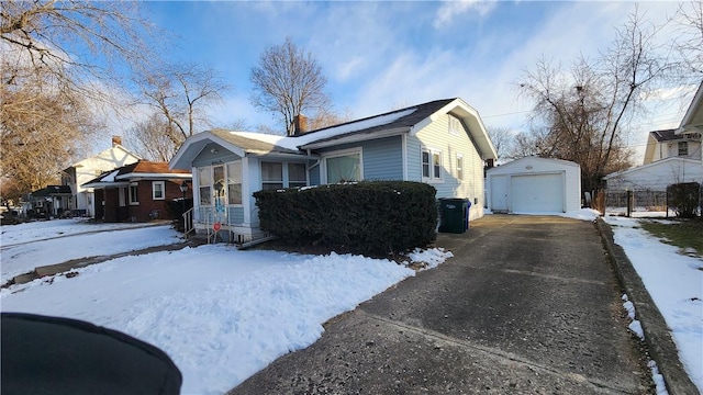 view of front of property featuring a garage and an outdoor structure