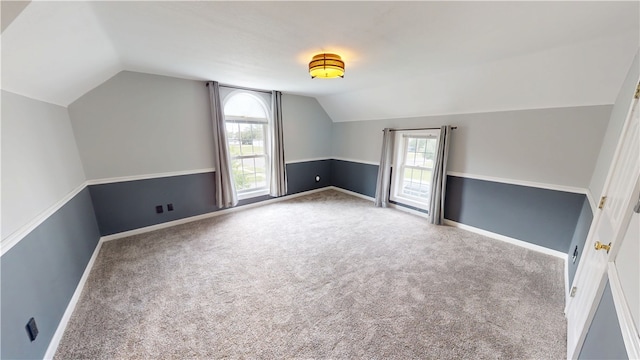 112 N 3rd St, Hoopeston, IL 60942 - additional living space featuring vaulted ceiling, plenty of natural light, carpet flooring, and baseboards