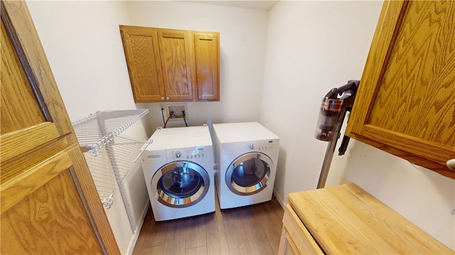 112 N 3rd St, Hoopeston, IL 60942 - laundry area featuring cabinet space, separate washer and dryer, wood finished floors, and baseboards