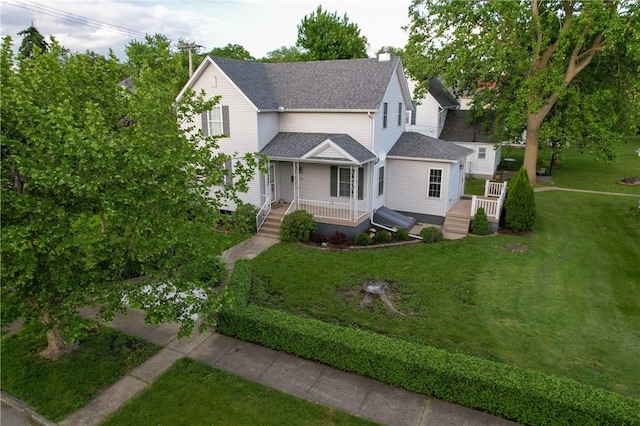 112 N 3rd St, Hoopeston, IL 60942 - view of front of property with roof with shingles, a front lawn, and covered porch